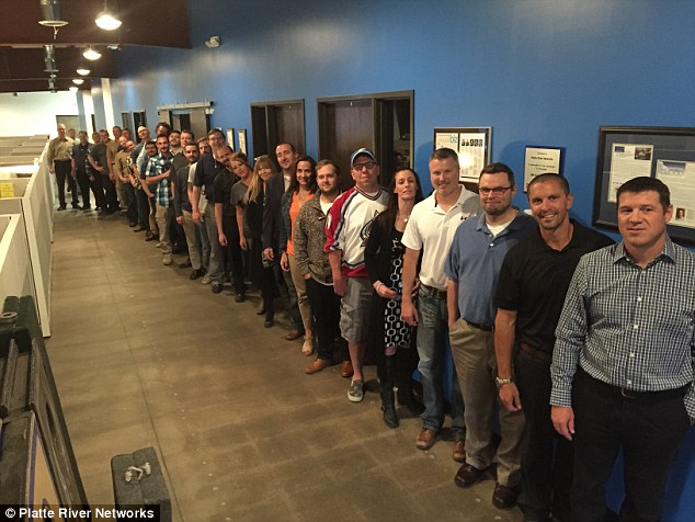 Open for business: Platte River Networks celebrated the opening of its new office with this group picture of staff. Former staff said the firm had been a fairly small-scale operation